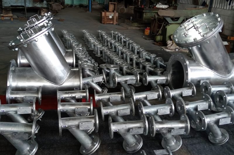 Fabricated stainless steel strainer assemblies laid out in the welding bay