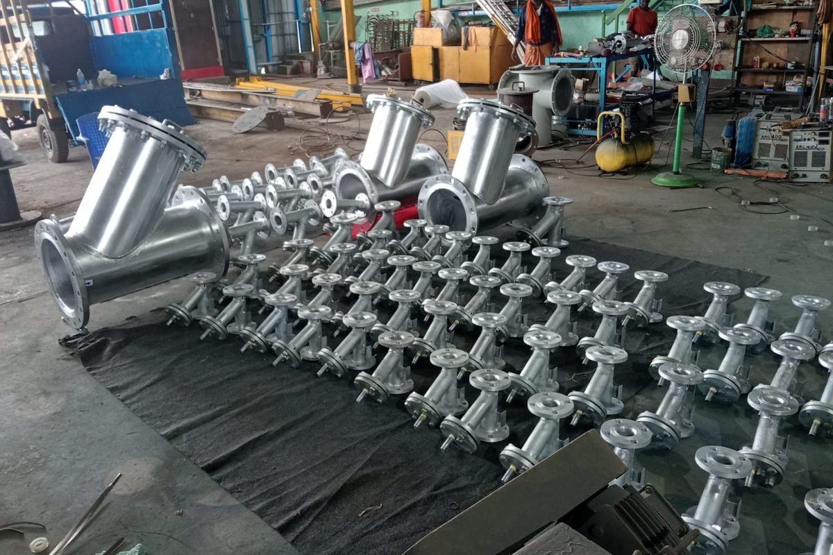Stainless steel Y-strainers and basket strainers side by side after fabrication