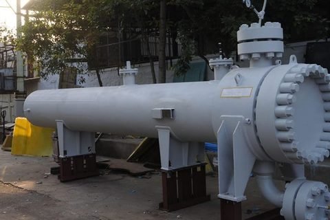 Shell and tube heat exchanger with bolted channel head, mounted on fabricated supports