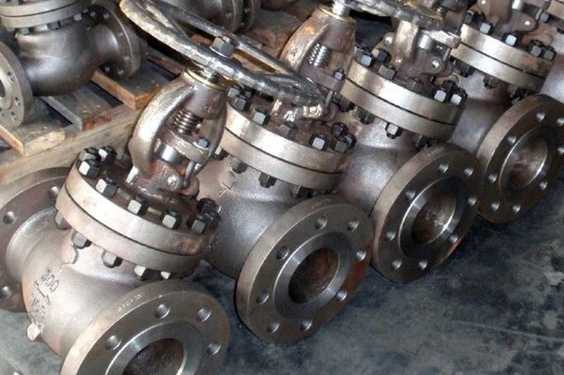 Batch of cast steel flanged globe and gate valves with rising stems and hand wheels, awaiting finishing at LKS Industries